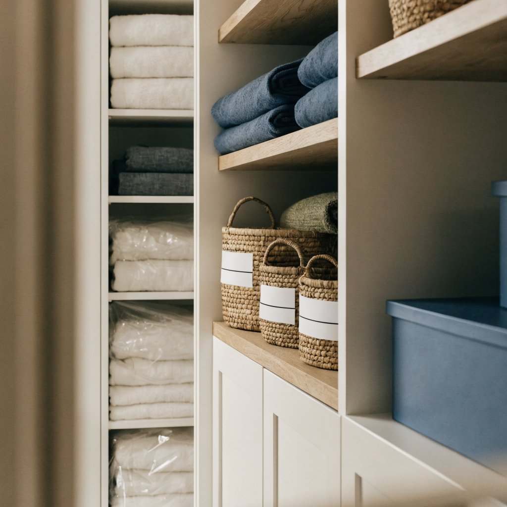 A beautifully organized closet with everything folded, labelled, and in its place